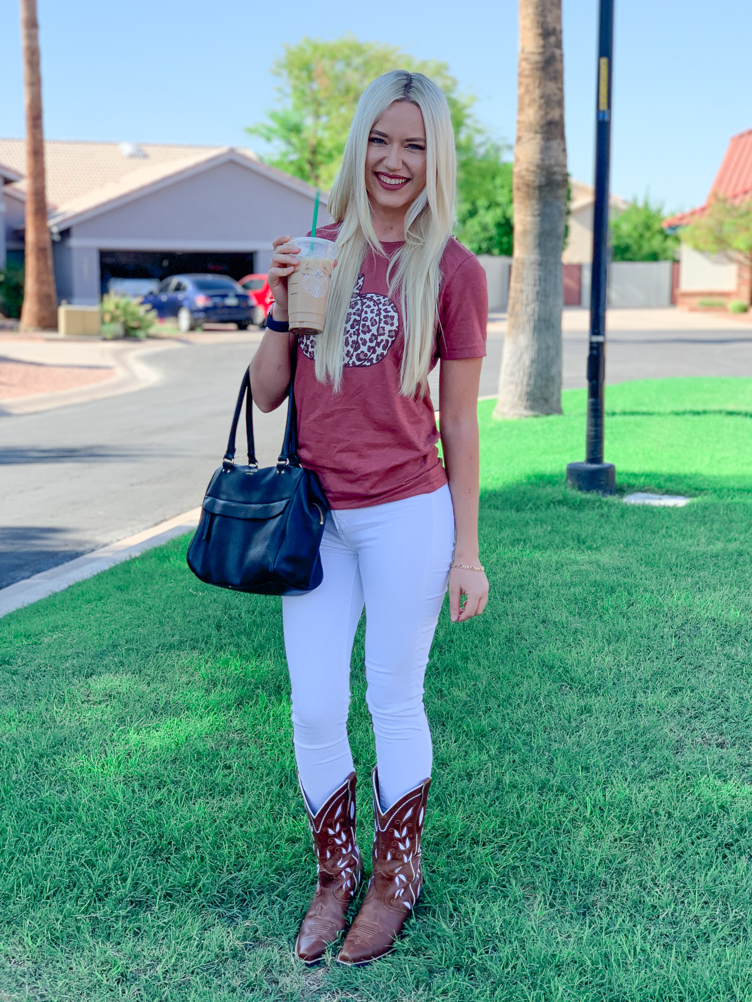Basic blogger holding a pumpkin spice latte and wearing a pumpkin t-shirt