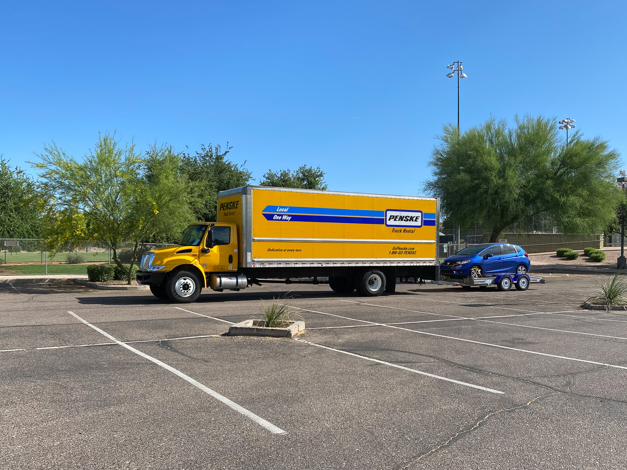 Shay and Stephen's moving truck with a trailer and car attached